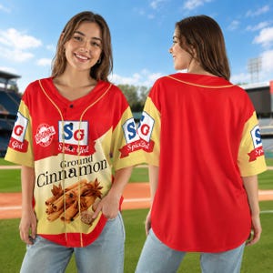 May include: A red and yellow button-down baseball jersey featuring a graphic print of a cinnamon spice container. The front displays the text "SG Spice Girl" and "Ground Cinnamon" with an image of cinnamon sticks. The back is solid red.