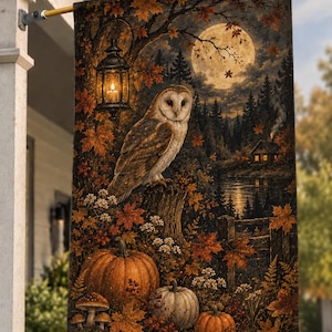 May include: A rectangular garden flag featuring a barn owl perched on a tree stump, surrounded by autumn maple leaves, pumpkins, and mushrooms. A glowing lantern hangs from a branch above, with a full moon and a cabin by a lake in the background.