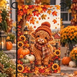 May include: A rectangular garden flag featuring a fluffy highland calf wearing a knit beanie and a plaid scarf. The scene includes orange pumpkins, sunflowers, a rustic lantern, and a red barn in the background, all surrounded by autumn leaves.