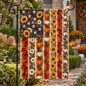 May include: A rectangular garden flag featuring a patriotic-inspired design with a dark blue canton filled with white stars and yellow sunflowers. The flag displays vertical stripes composed of orange pumpkins, white pumpkins, sunflowers, red maple leaves, and white cotton bolls.