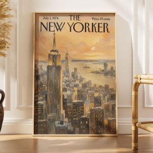 May include: A rectangular wall art print featuring a painted cityscape of New York City at sunset. The text at the top reads July 1, 1974, THE NEW YORKER, and Price 25 cents. The image depicts the Empire State Building in warm golden tones.