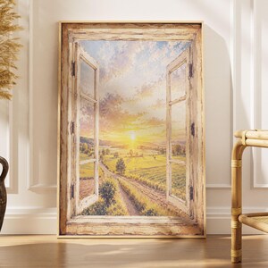 May include: A rectangular wall art print featuring an open wooden window frame looking out onto a rural landscape at sunset. The scene displays a dirt path winding through green fields under a bright yellow and orange sky with soft clouds.