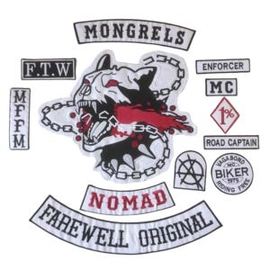May include: A collection of embroidered patches featuring a central dog head graphic with chains, red accents, and black details. Text includes MONGRELS, F.T.W, ENFORCER, MC, 1%, ROAD CAPTAIN, MFFM, NOMAD, FAREWELL ORIGINAL, VAGABOND BIKER RIDING FREE 1979, and a symbol.