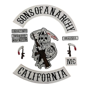 May include: A set of embroidered patches featuring the Sons of Anarchy logo, including a large reaper graphic holding a rifle and scythe, curved top and bottom rockers reading Sons of Anarchy and California, and smaller rectangular text patches.