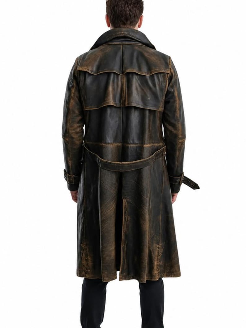 May include: A long, distressed dark brown leather trench coat featuring a wide collar, a back storm flap, and a matching waist belt with a buckle. The coat has long sleeves with buckled cuffs and a central back vent, showcasing a weathered finish.