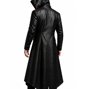 May include: A black long-length coat featuring a hood, long sleeves, and a structured fit. The garment is constructed with vertical seam detailing and a pointed, asymmetrical hemline that extends below the knees, crafted from a smooth material.