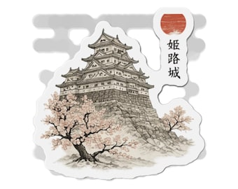 May include: A die-cut sticker featuring a detailed ink-style illustration of Himeji Castle perched on a stone foundation, surrounded by blooming cherry blossom trees. A red sun icon sits above the Japanese text 姫路城, which translates to Himeji Castle.
