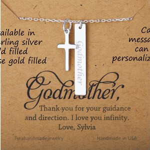 May include: Silver necklace with a cross charm and a pendant that says "Godmother". The card says "Card message can be personalized".