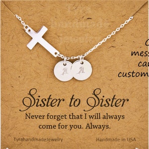 May include: Silver necklace with a cross charm and two personalized discs. The necklace comes with a card that says "Sister to Sister" and "Never forget that I will always come for you. Always."