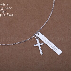 May include: Silver necklace with a cross charm and a personalized bar pendant that says "Goamoiher". The necklace is available in sterling silver, gold filled, or rose gold filled.