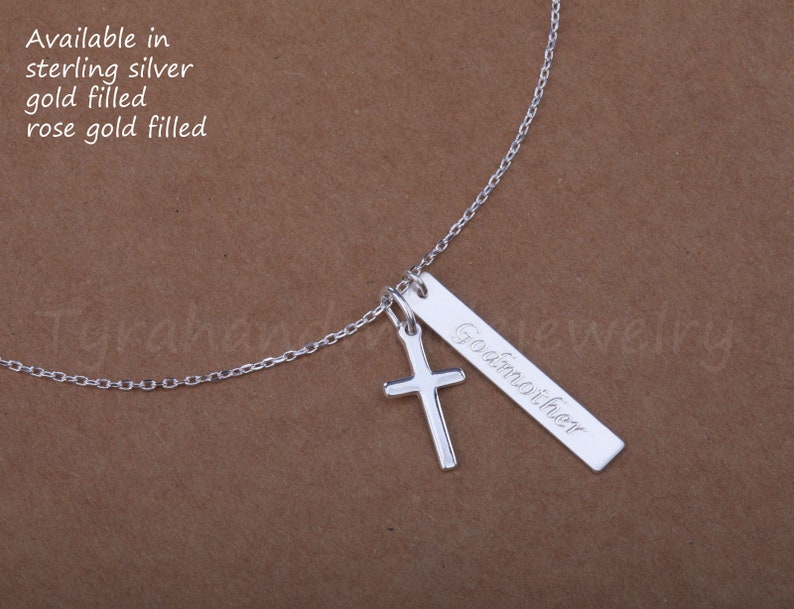May include: Silver necklace with a cross charm and a personalized bar pendant that says "Goamoiher". The necklace is available in sterling silver, gold filled, or rose gold filled.