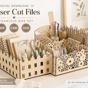 May include: A digital download set of laser cut files for an organiser box set. The image displays two wooden desk organisers with intricate cutouts, one featuring a picket fence design and the other a floral pattern, holding various stationery items.