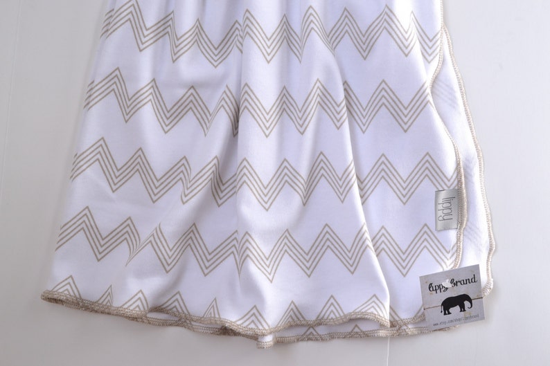 Baby blanket. Zig zag chevron print. Soft stretchy knit material. Size 31 by 40 inches. Colors beige and white. Unisex baby blanket. image 5