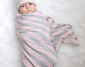 Large swaddle blanket. Pink/ gray stripes. Soft and stretchy knit fabric. Size 45 by 45 inches. Made by lippy brand.
