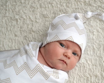 Neutral chevron baby hat. Knot top style, adjustable. Tan and white skinny chevron print. Made by lippybrand.