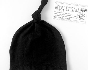 Solid black baby hat. Knot style. Soft stretchy knit. Gender neutral photo prop. Adjustable. Size: Newborn/XS (Made by lippy brand)
