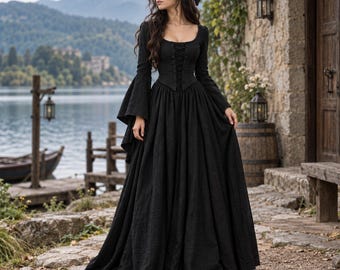 May include: A floor-length black dress featuring a square neckline, long flared sleeves, and a lace-up corset-style bodice. The garment has a fitted waist that transitions into a full, flowing skirt with a textured fabric finish and long hemline.