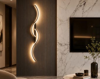 May include: A vertical wall-mounted light fitting featuring two interlocking, curved black metal arms that emit a warm, soft glow along their inner edges, creating a continuous S-shaped illumination pattern against a dark, ribbed wall panel.