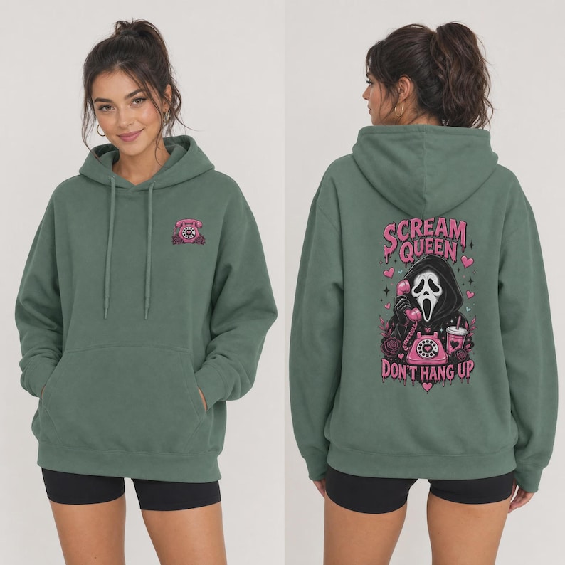 May include: A sage green hooded sweatshirt featuring a small pink rotary phone graphic on the front left chest. The back displays a large graphic of a masked figure holding a pink rotary phone with the text Scream Queen Don't Hang Up.