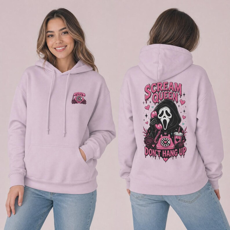 May include: A light purple hooded sweatshirt featuring a small pink rotary phone graphic on the front left chest. The back displays a large graphic of a masked figure holding a pink rotary phone with the text Scream Queen Don't Hang Up.