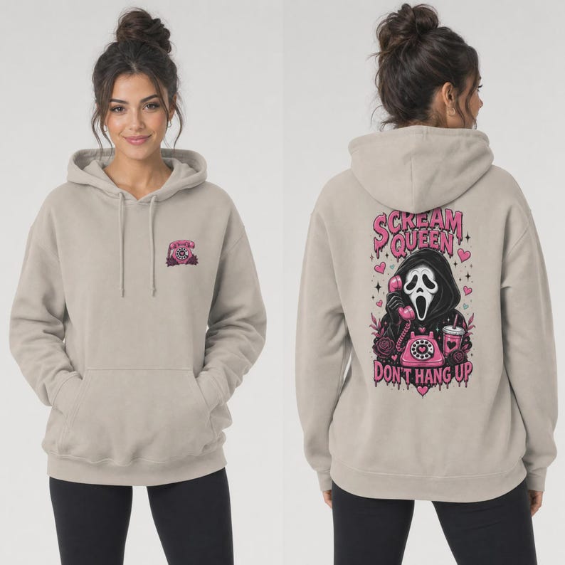 May include: A beige hooded sweatshirt featuring a small pink rotary phone graphic on the front left chest. The back displays a large graphic of a masked figure holding a pink rotary phone with the text Scream Queen Don't Hang Up in pink.