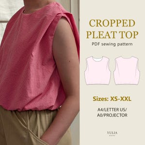 May include: A pink gingham sleeveless top with pleated shoulders and a round neckline. The image includes text: CROPPED PLEAT TOP, PDF sewing pattern, Sizes: XS-XXL, A4/LETTER US/A0/PROJECTOR, and YULIA atelier, alongside a line drawing of the top.