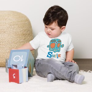 Kids Graphic Tee – SMILE Magu Shirt | Third-Eye Monster Character | Conscious Kids Clothing for the Whole Family | Toddler & Youth Gift