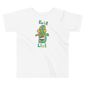 Kids Graphic Tee – ENJOY LIFE Magu Shirt | Third-Eye Monster Character | Joyful Conscious Kids Clothing for the Family | Toddler & Youth