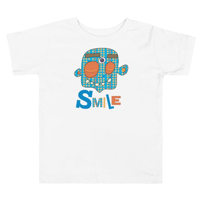 Kids Graphic Tee – SMILE Magu Shirt | Third-Eye Monster Character | Conscious Kids Clothing for the Whole Family | Toddler & Youth Gift