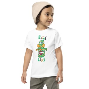 Kids Graphic Tee – ENJOY LIFE Magu Shirt | Third-Eye Monster Character | Joyful Conscious Kids Clothing for the Family | Toddler & Youth