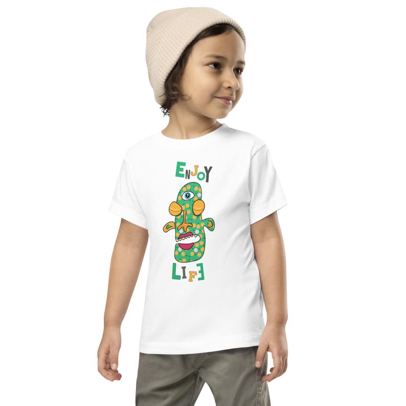 Kids Graphic Tee – ENJOY LIFE Magu Shirt | Third-Eye Monster Character | Joyful Conscious Kids Clothing for the Family | Toddler & Youth
