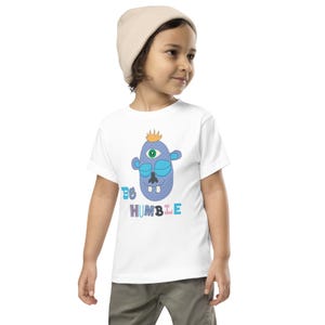 Kids Graphic Tee – BE HUMBLE Magu Shirt | Third-Eye Monster Character | Conscious Kids Clothing for the Whole Family | Toddler & Youth Gift