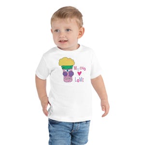 Kids Graphic Tee – MUCHO LOVE Magu Shirt | Third-Eye Monster Character | Conscious Kids Clothing for the Whole Family | Toddler & Youth Gift
