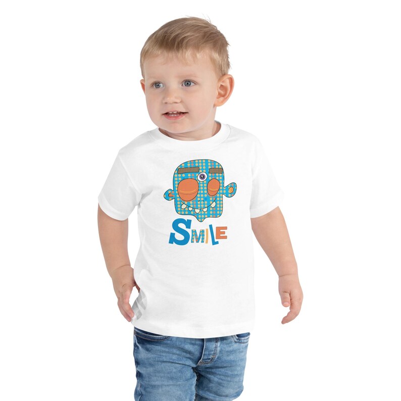 Kids Graphic Tee – SMILE Magu Shirt | Third-Eye Monster Character | Conscious Kids Clothing for the Whole Family | Toddler & Youth Gift