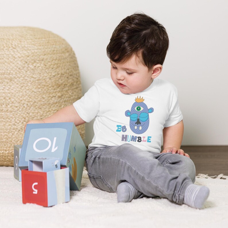 Kids Graphic Tee – BE HUMBLE Magu Shirt | Third-Eye Monster Character | Conscious Kids Clothing for the Whole Family | Toddler & Youth Gift