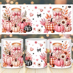May include: A white ceramic mug featuring a repeating pattern of pink and orange pumpkins, autumn leaves, flowers, and a coffee cup with a pink bow and the word fall. The design includes small hearts, stars, and black and white plaid accents.