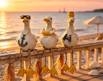 May include: Three off-white seagull figurines with dangling rope legs and yellow webbed feet. The left gull wears black sunglasses and an anchor necklace. The center gull wears a yellow life preserver. The right gull wears a yellow hat and binoculars.