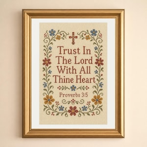 May include: A framed cross-stitch embroidery on beige fabric featuring the text Trust In The Lord With All Thine Heart Proverbs 3:5 in dark red letters. The design includes a small red cross and a floral border with blue, red, and yellow flowers.