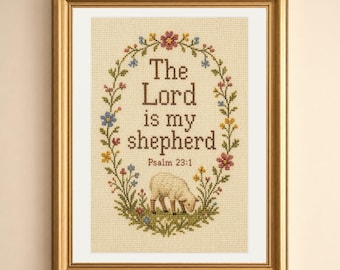 May include: A framed cross-stitch embroidery on cream fabric featuring the text The Lord is my shepherd Psalm 23:1 in brown letters. The text is surrounded by an oval floral wreath with small colorful flowers and a small sheep at the bottom.