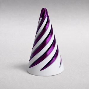 May include: A conical object featuring a spiraling pattern of alternating white and metallic purple bands. The structure has a smooth, rounded top and a wide, circular base, creating a distinct geometric shape with a glossy finish.