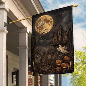 May include: A rectangular vertical flag featuring a Halloween scene with a large full moon, a haunted house, two ghosts, bats, a graveyard with a skeleton hand emerging from a grave, and several lit jack-o'-lanterns with candles on the ground.