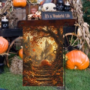 May include: A rectangular garden flag featuring an autumn scene with stone steps leading toward a castle silhouette under a large tree with orange leaves. A pumpkin sits on the steps, and a lantern glows on a stone pillar in the warm light.