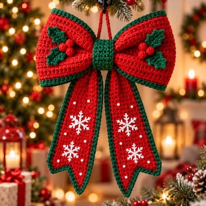 May include: A large, handmade crochet Christmas bow in vibrant red with dark green trim. The bow features two green holly leaf appliqués with red berries on the top loops and white embroidered snowflake patterns on the two hanging tails.
