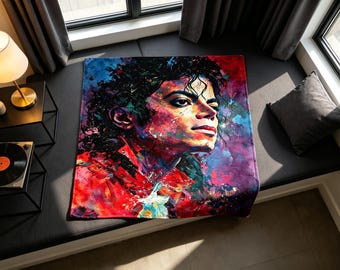 Könnte beinhalten: Eine rechteckige Fleecedecke mit einem lebendigen, abstrakten, mehrfarbigen Porträt von Michael Jackson. Das Kunstwerk verwendet kräftige Spritzer in Rot, Blau, Lila und Schwarz, um sein Gesicht und seine Haare auf ausdrucksstarke Weise darzustellen.