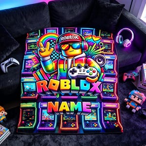 May include: A rectangular blanket featuring a vibrant, neon-colored graphic of a Roblox character wearing a cap, headphones, and sunglasses while holding a game controller. The design includes the text ROBLOX and NAME, surrounded by arcade machines.