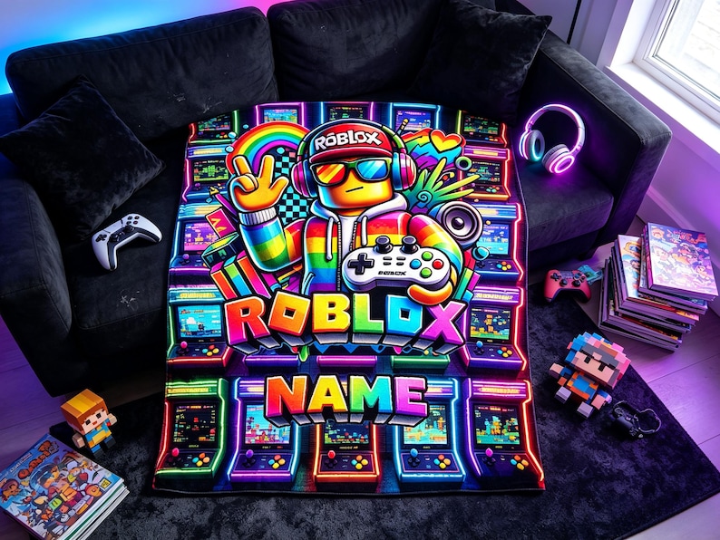 May include: A rectangular blanket featuring a vibrant, neon-colored graphic of a Roblox character wearing a cap, headphones, and sunglasses while holding a game controller. The design includes the text ROBLOX and NAME, surrounded by arcade machines.