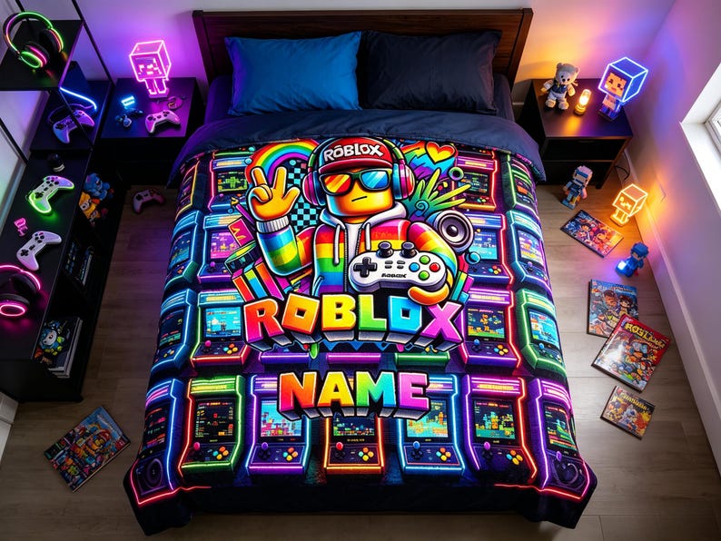 May include: A vibrant bed comforter featuring a central character wearing headphones and sunglasses, holding a game controller. The design includes neon-colored arcade machines, the text ROBLOX, and a customizable NAME section in a bold, colorful font.