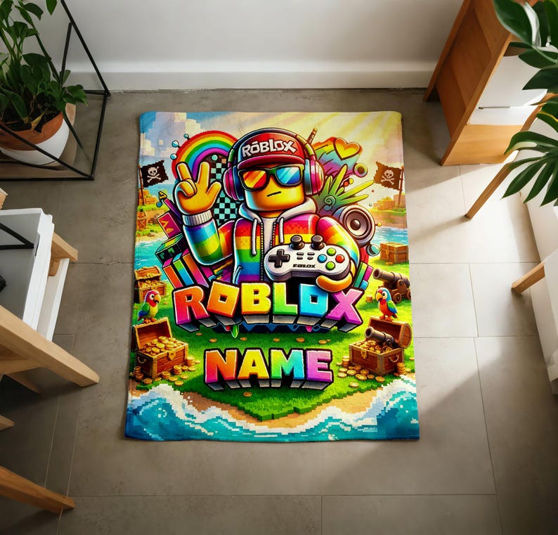 May include: A rectangular blanket featuring a colorful Roblox-themed graphic. A character wearing headphones, sunglasses, and a rainbow hoodie holds a game controller. The design includes treasure chests, parrots, cannons, and the text Roblox and Name.