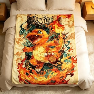 May include: A rectangular fleece blanket featuring a vibrant, stylized illustration of the orange fire-type creature Charmander surrounded by swirling flames and smoke, with Japanese kanji characters printed in a circular emblem at the top.