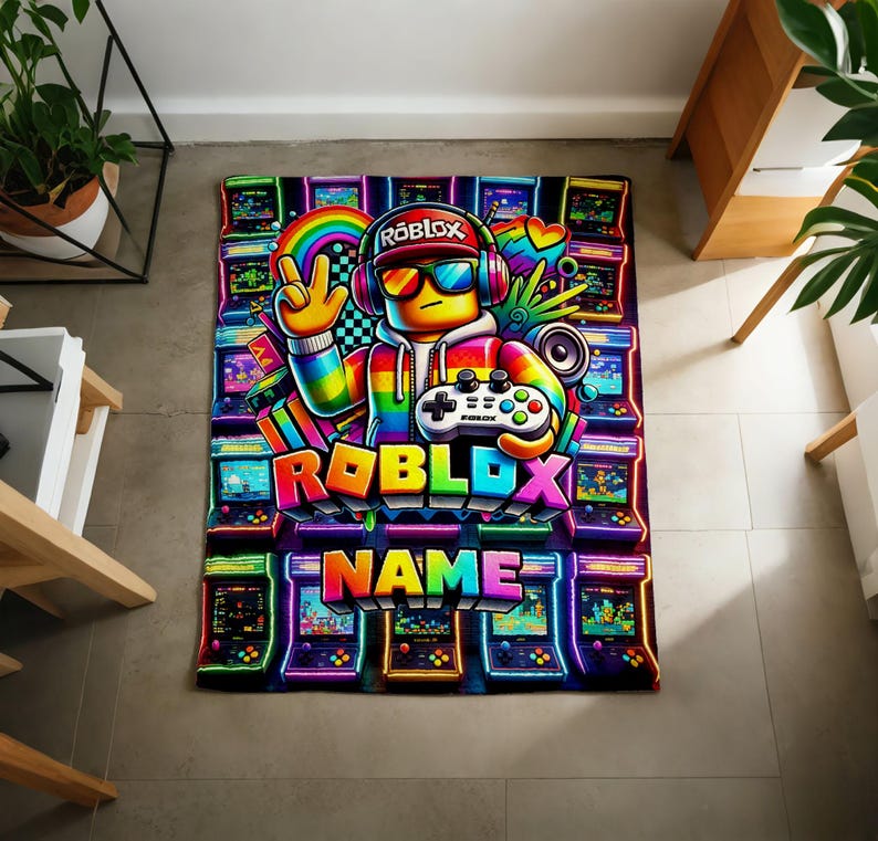 May include: A rectangular blanket featuring a vibrant, neon-colored graphic of a Roblox character wearing headphones and sunglasses, holding a game controller. The design includes multiple arcade cabinets, a rainbow, and the text Roblox and Name.